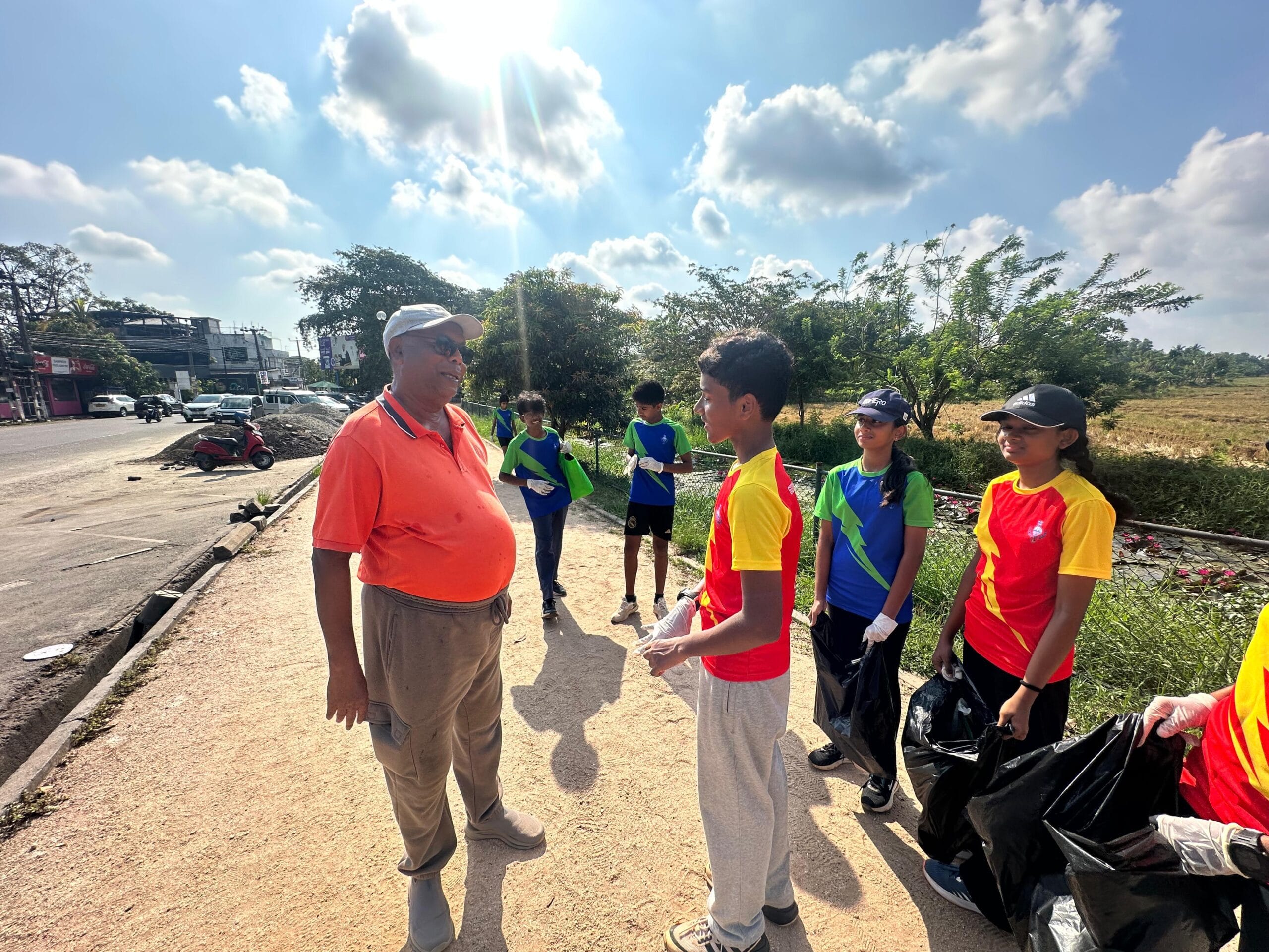 Guiding Steps College students speaking with a member of the public during their clean-up campaign