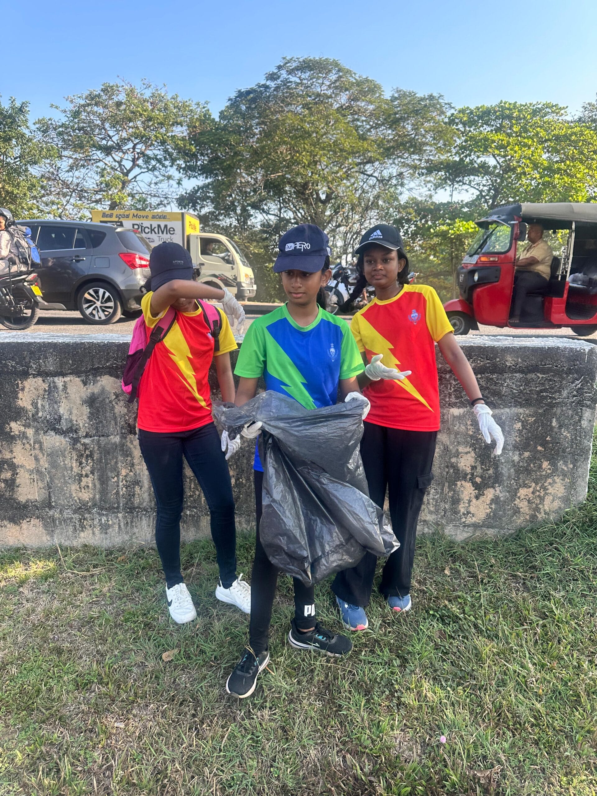 Three Guiding Steps College students with a litter bag during the environmental clean-up